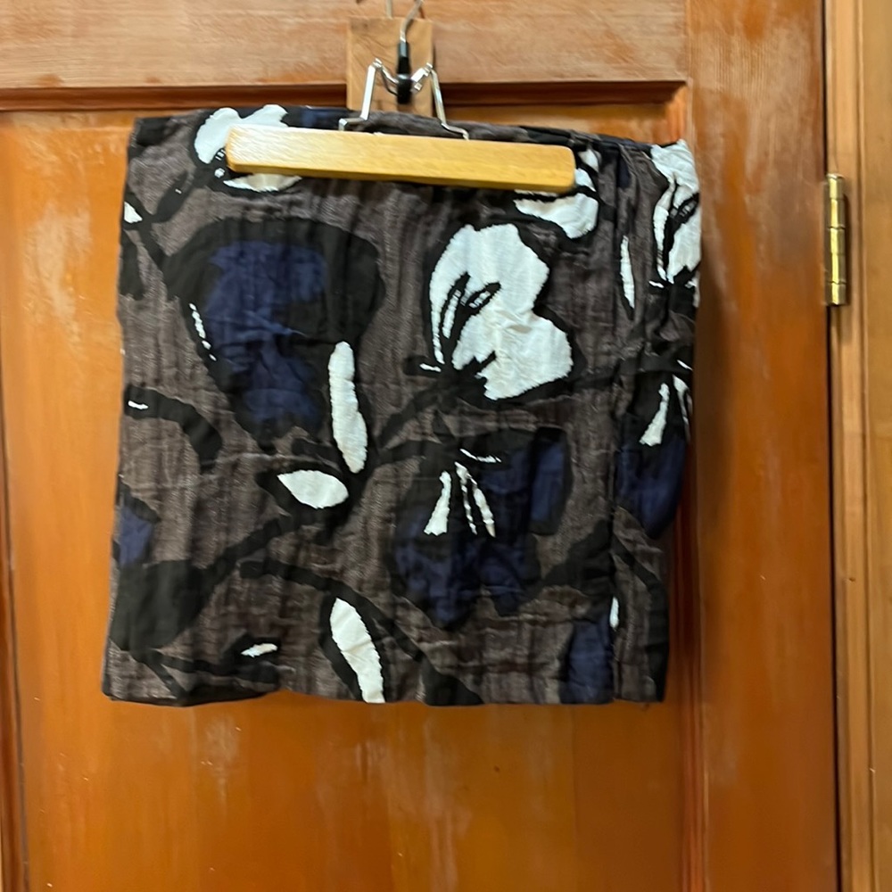 Size 4 apostrophe form fitting mini skirt.  Brown with large floral pattern.